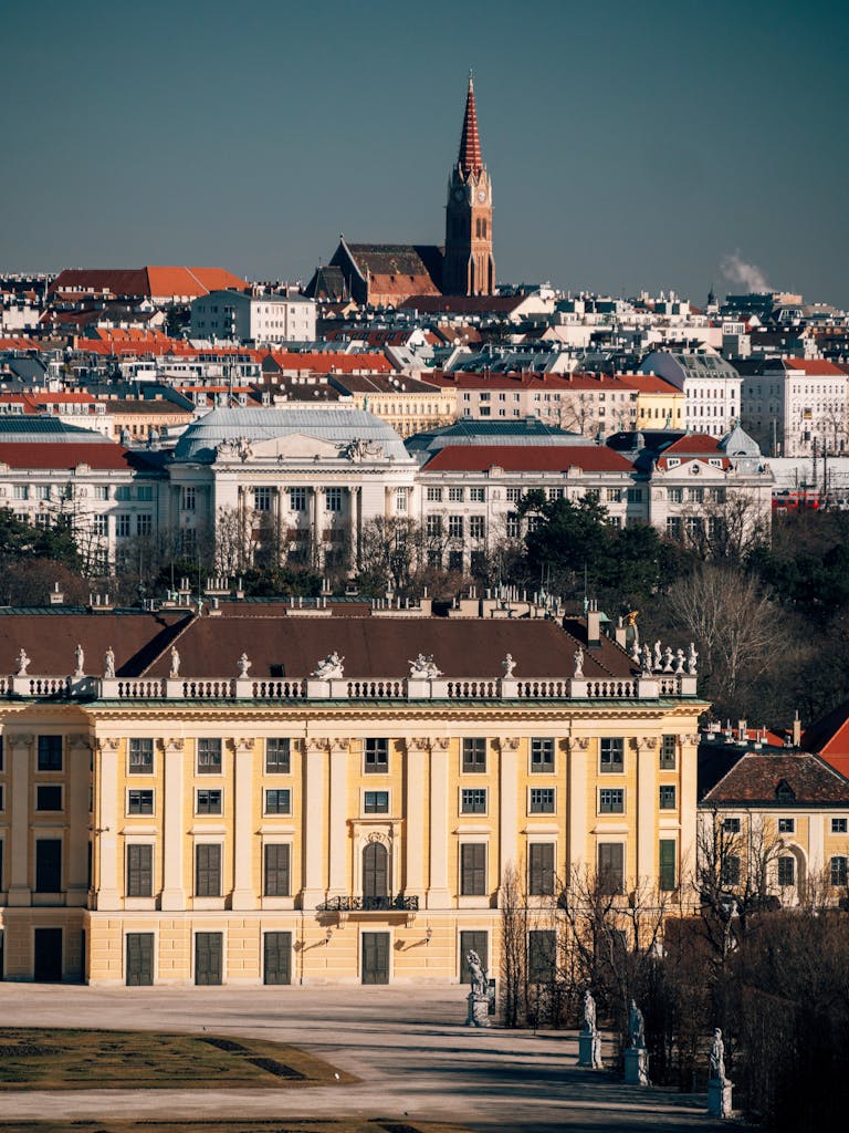 Stunning view of Schonbrunn Palace with Vienna cityscape backdrop showcasing historical architecture.