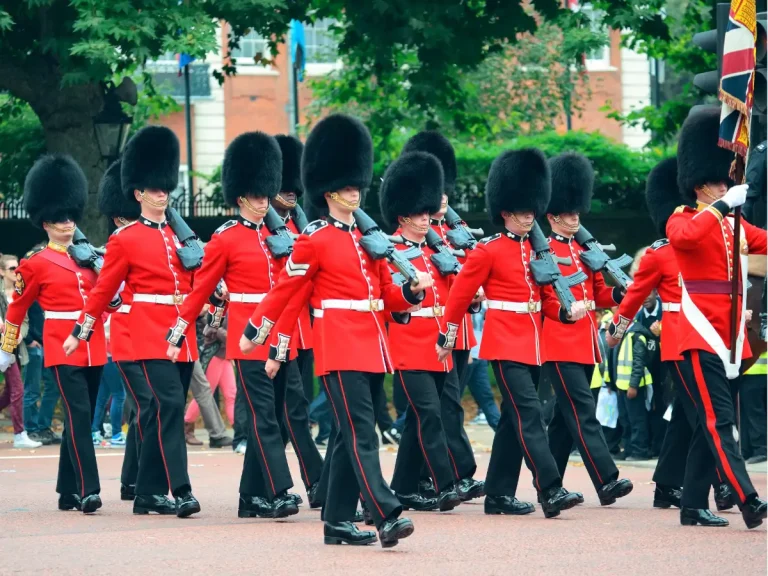 Changing of the Guard ceremony in London with guards in red uniforms and bearskin hats