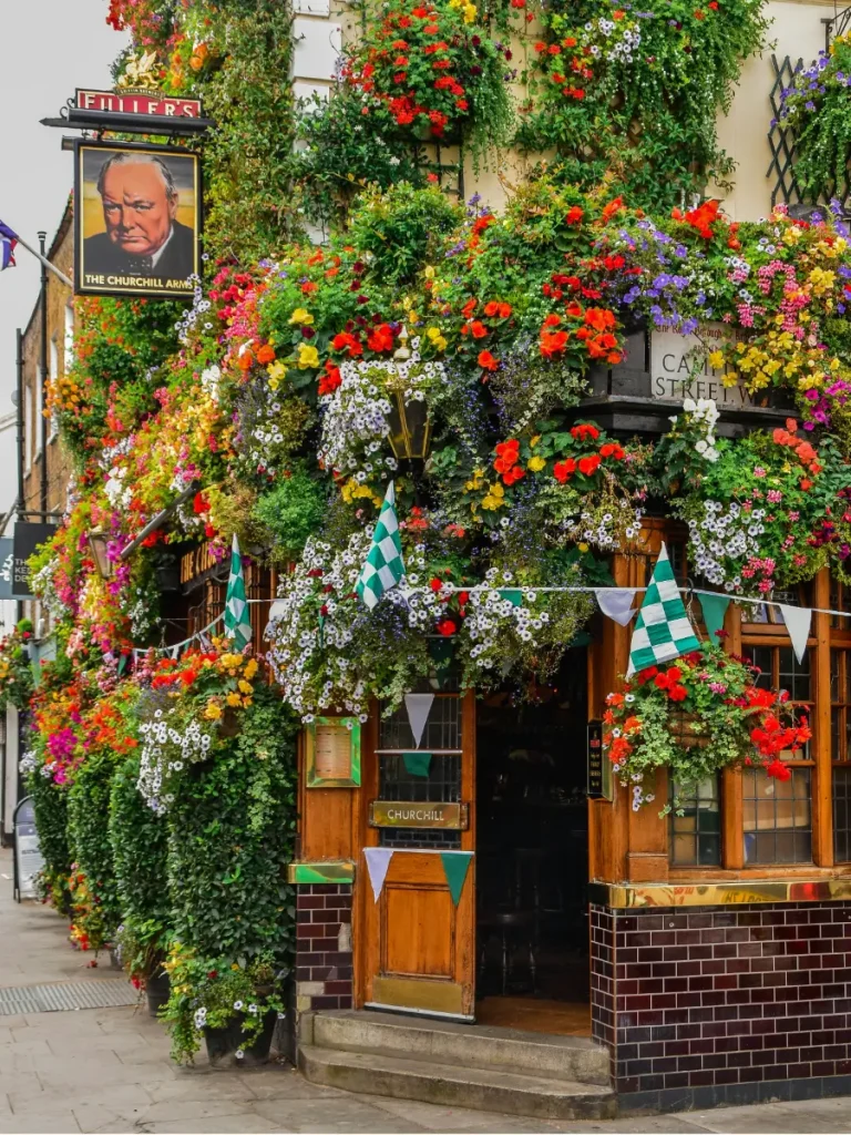 The Churchill Arms pub in Kensington London covered in colorful flowers