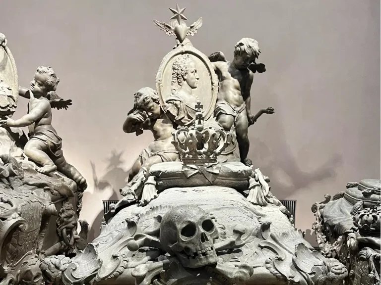 Ornate skull and crown details on a Habsburg sarcophagus inside the Imperial Crypt Vienna.