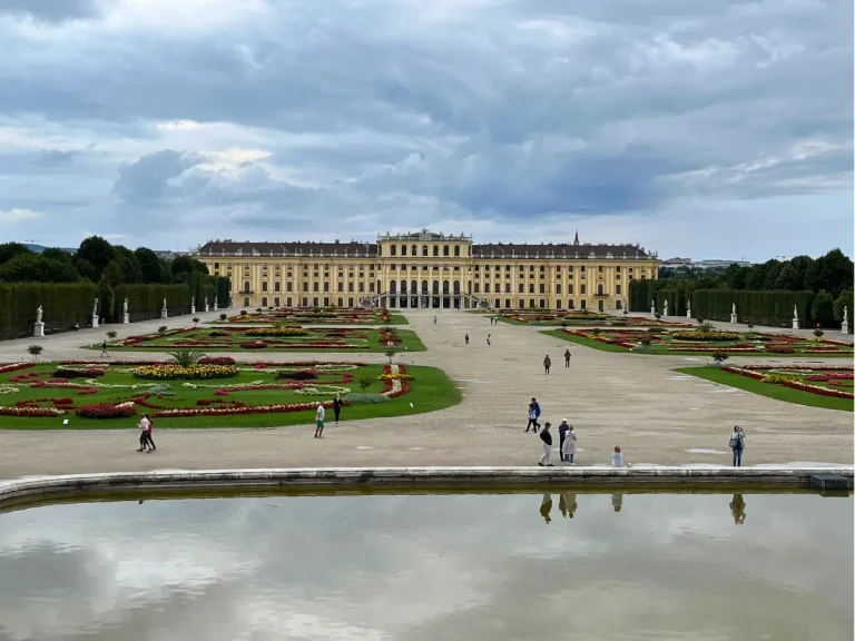Elevated view of the gardens and palace grounds at Schönbrunn Palace in Vienna under dramatic clouds