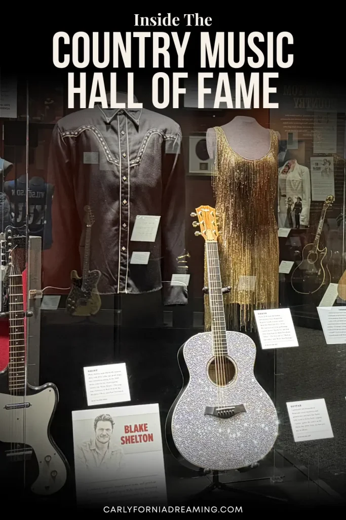 Taylor Swift's rhinestone-covered guitar and country music costumes on display inside the Country Music Hall of Fame in Nashville.