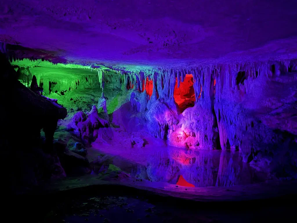 Multicolored cave formations reflected in pools of water inside Raccoon Mountain Caverns in Chattanooga, Tennessee