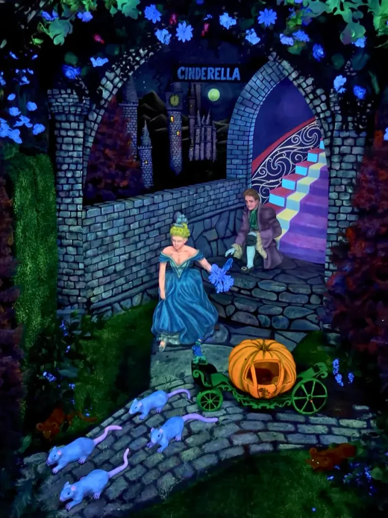 Cinderella display inside Fairyland Caverns at Rock City Gardens, illuminated by colorful black-light effects.
