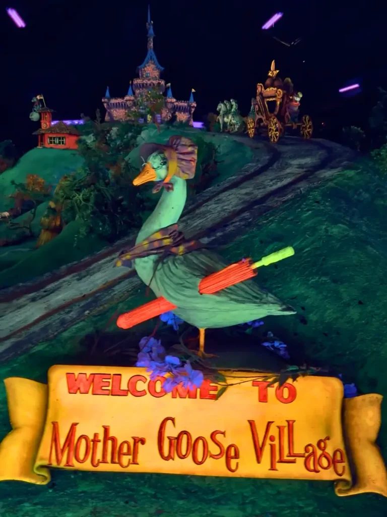 Mother Goose Village inside Fairyland Caverns at Rock City Gardens, featuring glowing nursery rhyme displays under black lights.