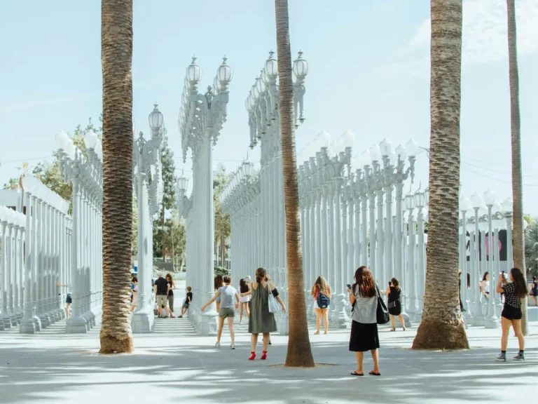 Visitors walking among the Urban Light installation outside LACMA in Los Angeles.