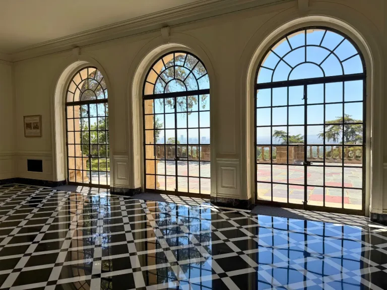 Arched windows and black-and-white marble floor in the Card Room at Greystone Mansion