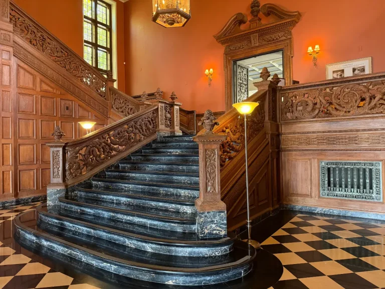 Carved wood railings and marble steps of the Grand Staircase at Greystone Mansion