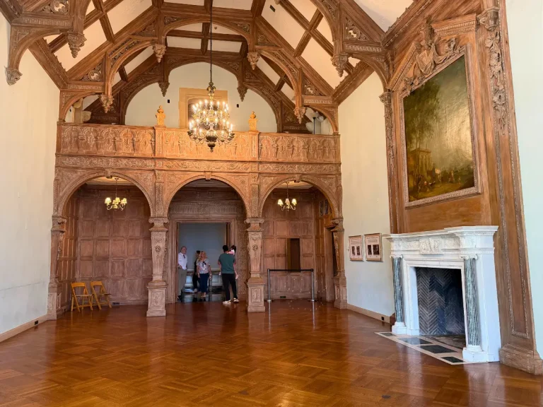 Alt: Living Room and carved wood Minstrel Gallery inside Greystone Mansion