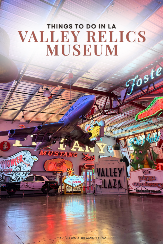 Vintage neon signs and a suspended airplane inside the Valley Relics Museum in Van Nuys, a unique museum and thing to do in Los Angeles.