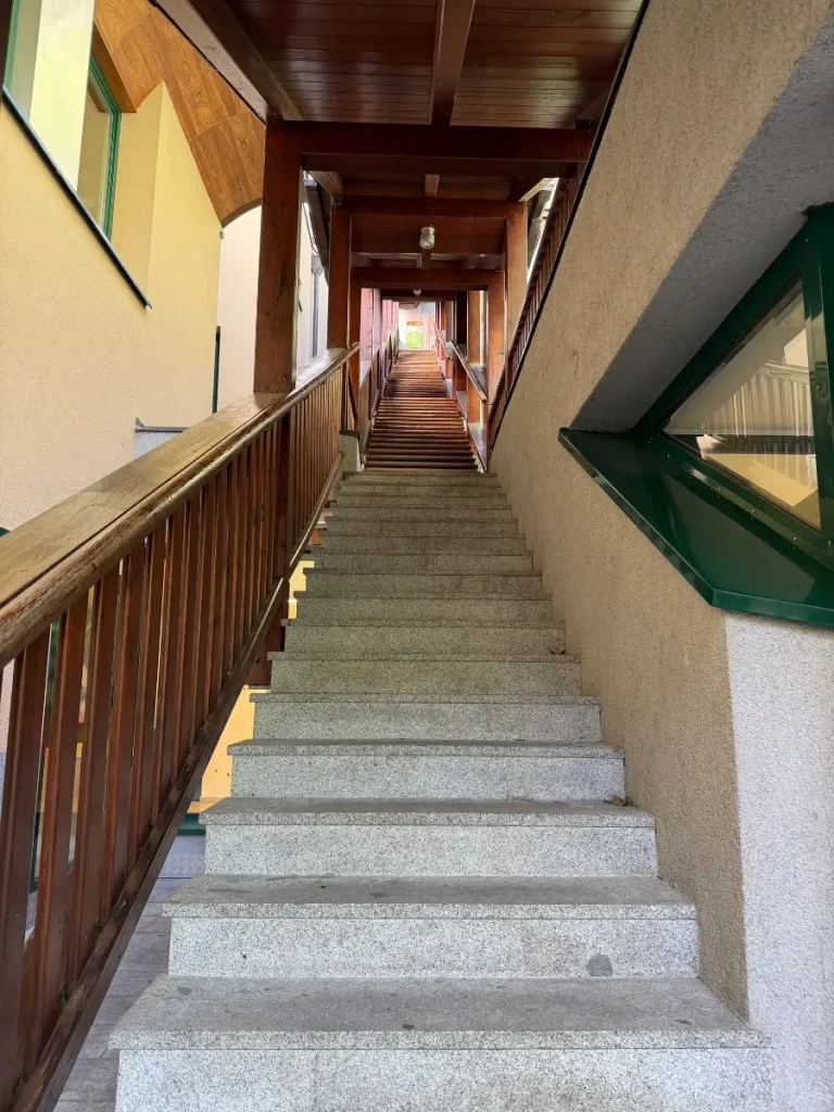 Steep staircase with wooden railings and a covered walkway at the beginning of the Sound of Music Trail in Werfen, Austria.